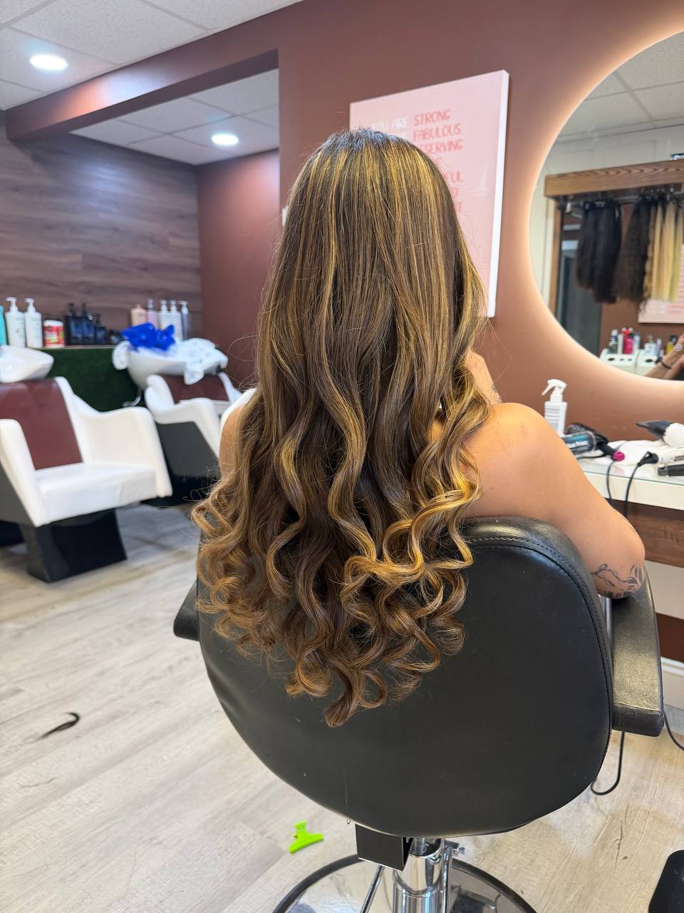 Long caramel balayage waves styled at Beauty Space in Dracut, MA — client photographed from behind in the salon
